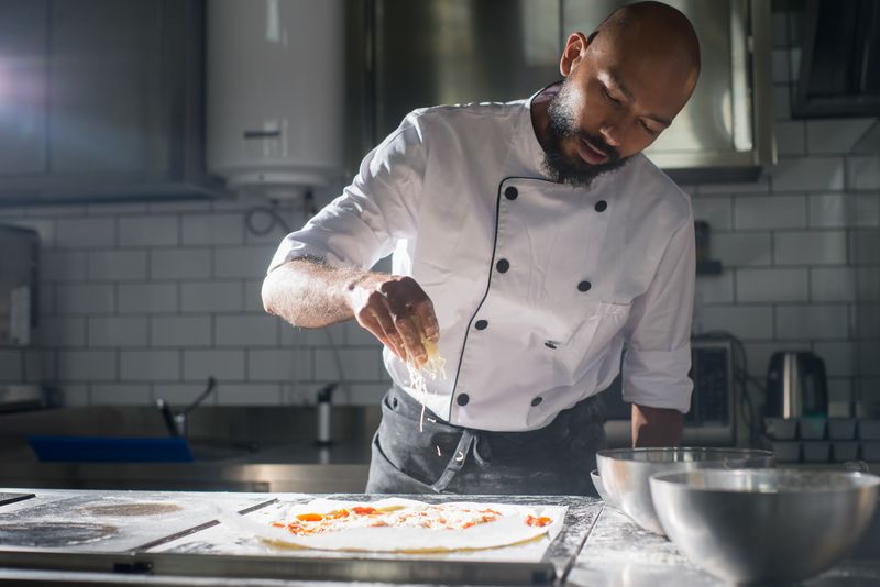 Pizza inn team working together in restaurant kitchen